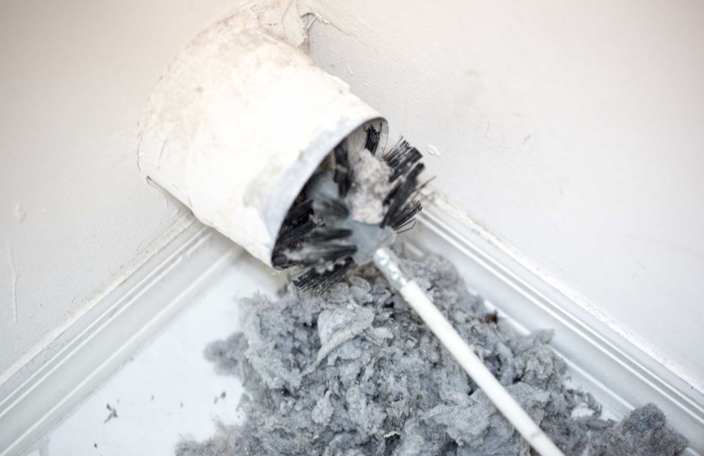 Rotary brush pulling out years of compressed lint from a dryer vent